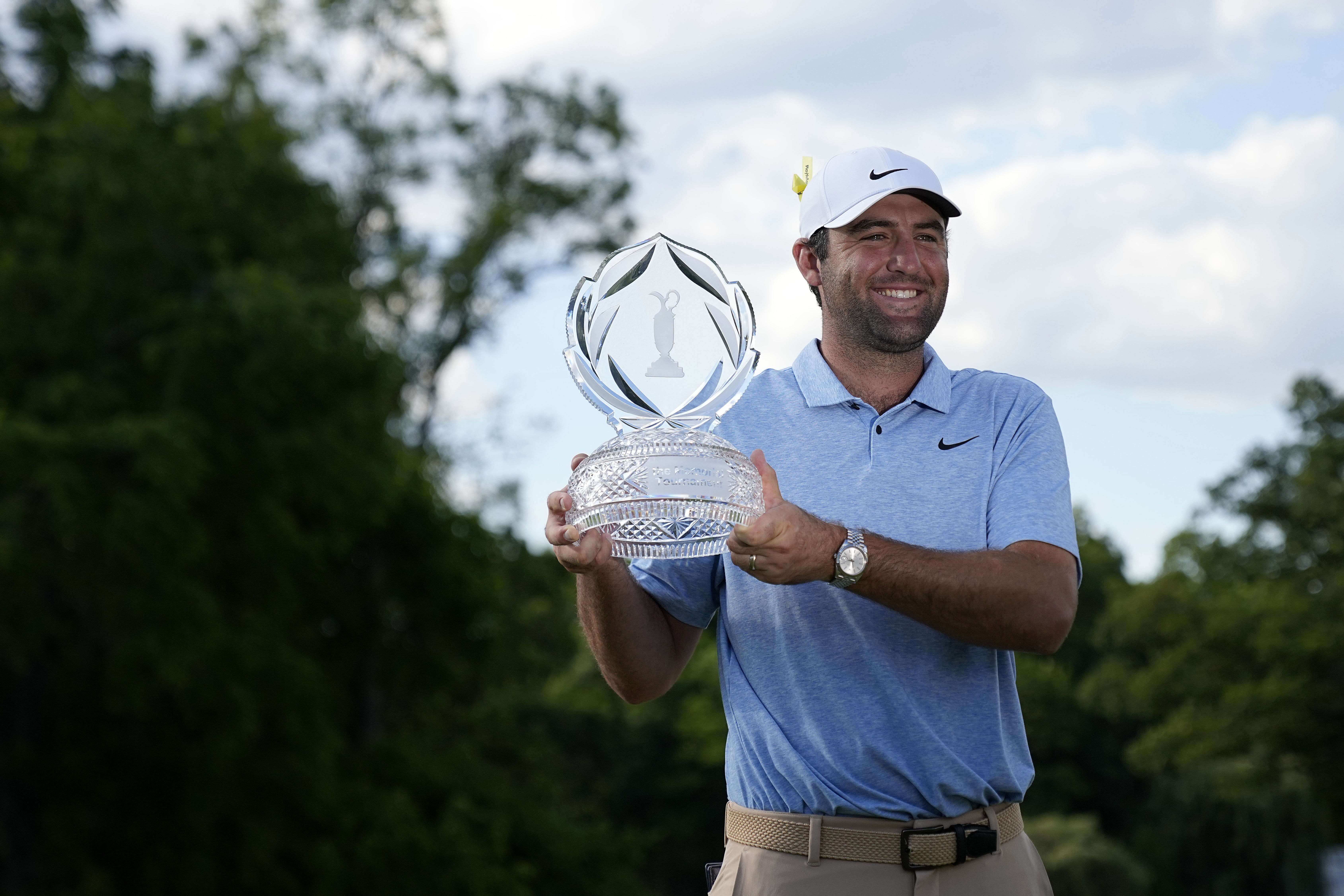 Scottie Scheffler lifts the 2024 Memorial Tournament trophy - Image Source: Imagn
